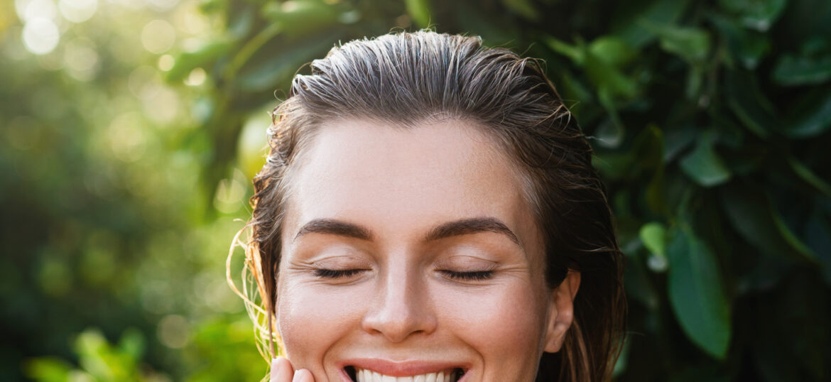 Portrait of beautiful woman with smooth skin against lemon trees